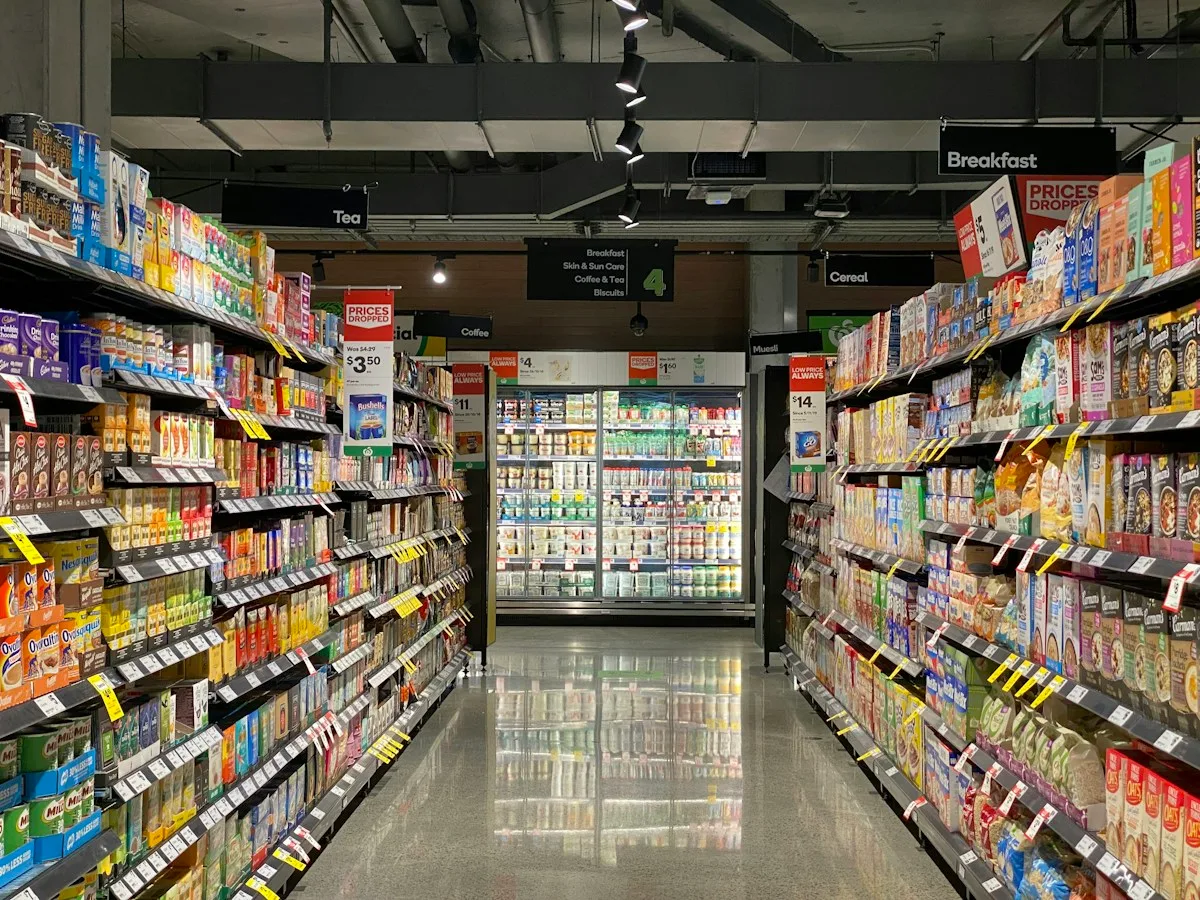 Clean organized shelving in a compact grocery store format